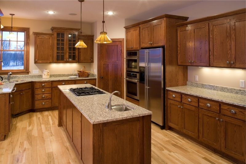 A custom-made kitchen with an island and fitted appliances