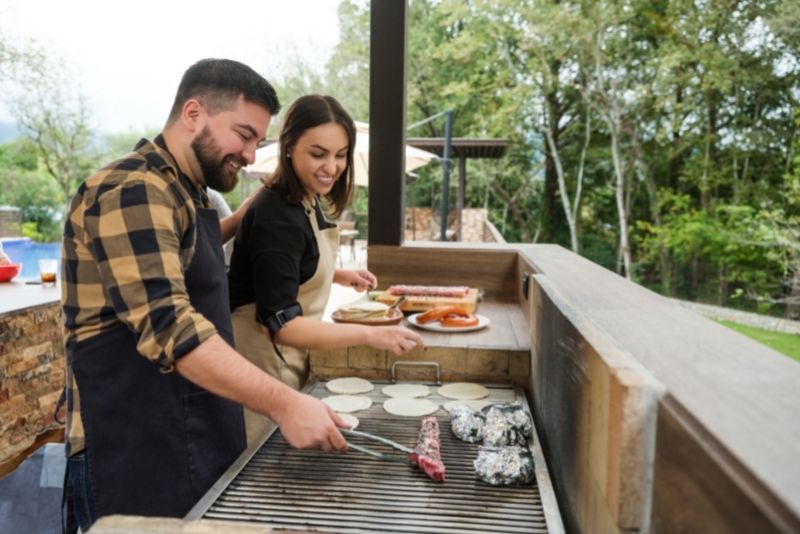 An outdoor kitchen with a grill