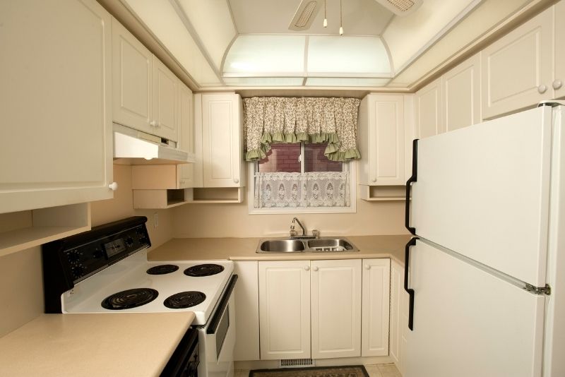 A small kitchen fitted with cabinets and appliances